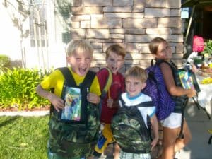 USA residents with free backpacks given as part of a USA employee school supply drive